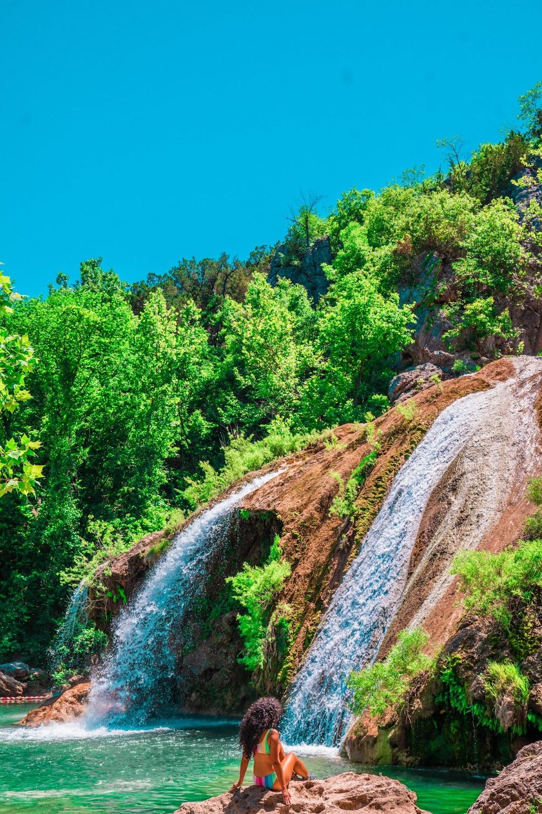 a waterfall on a rocky hill