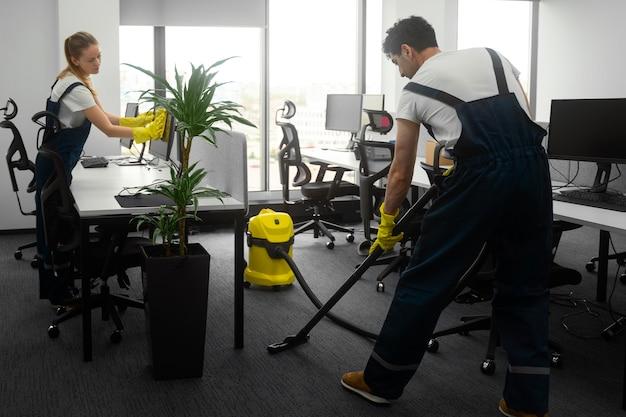 Full shot people cleaning office