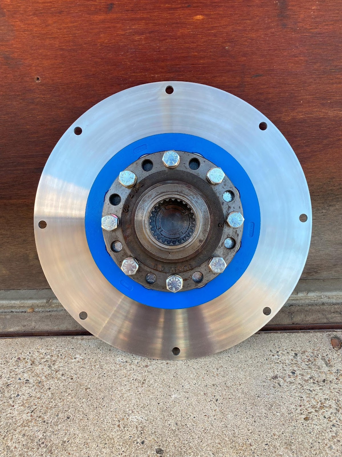 A circular metal object with blue band  Description automatically generated