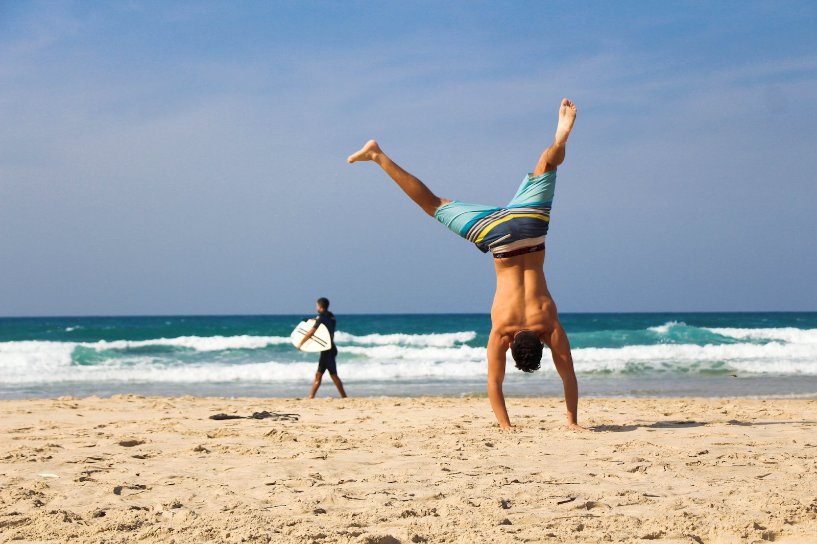 Man Doing Cartwheel at the Beach