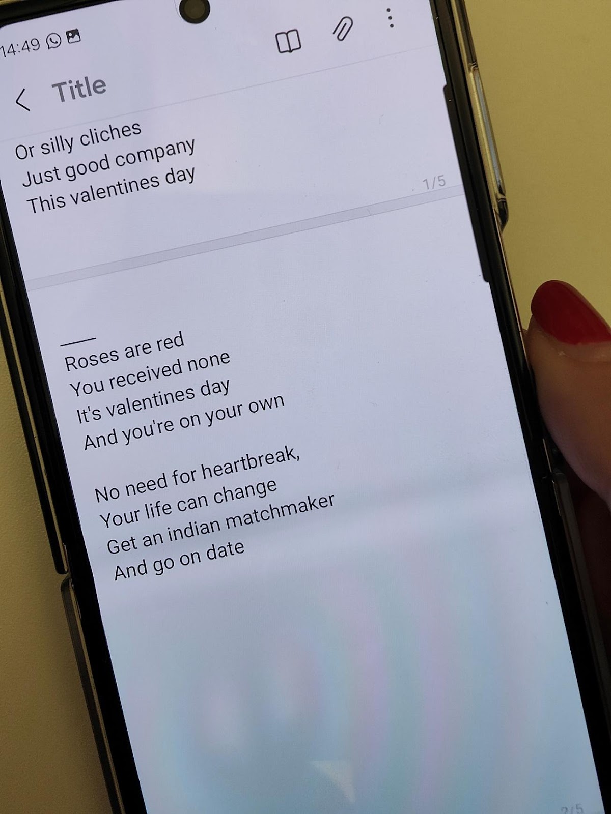 A hand holding a phone with text on it

Description automatically generated