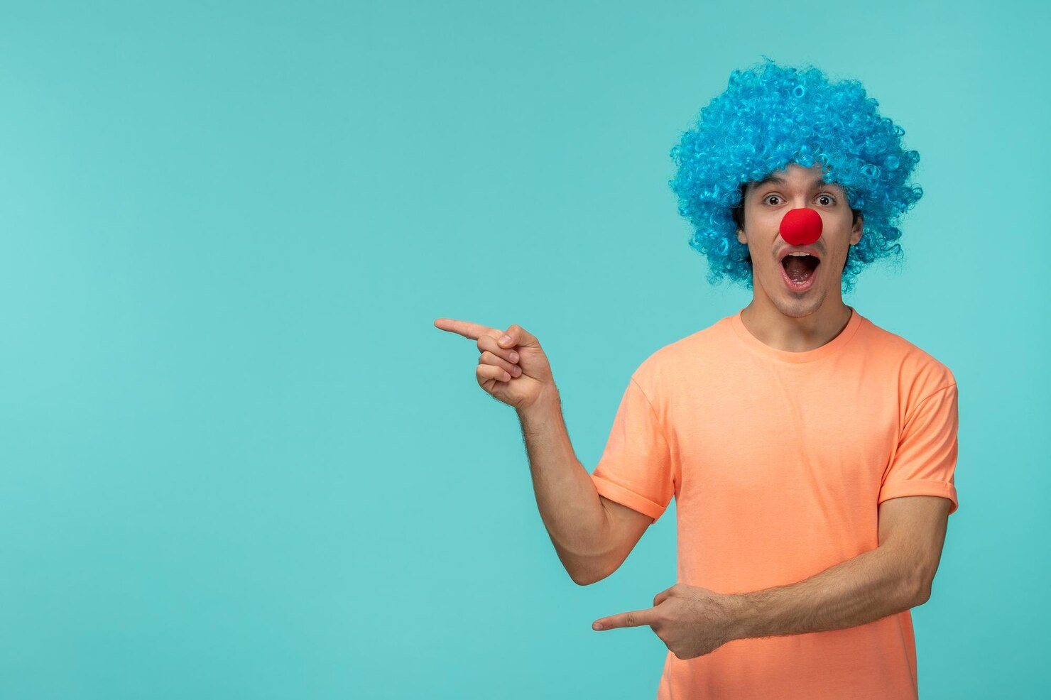 A person dressed as a clown and pointing sideways.