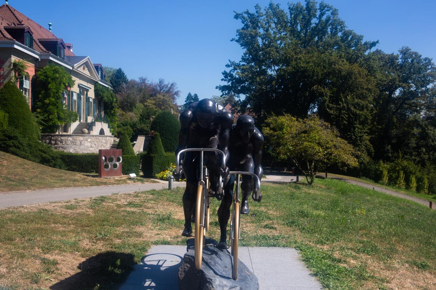 A statue of a cyclist on a bike

Description automatically generated