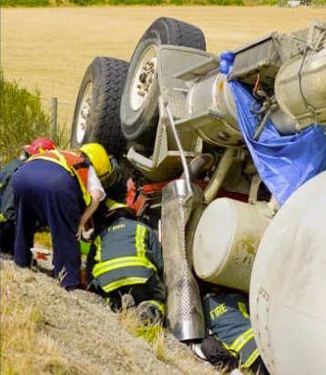 A group of firefighters working on a truckDescription automatically generated