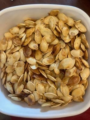 A bowl of pumpkin seeds

Description automatically generated