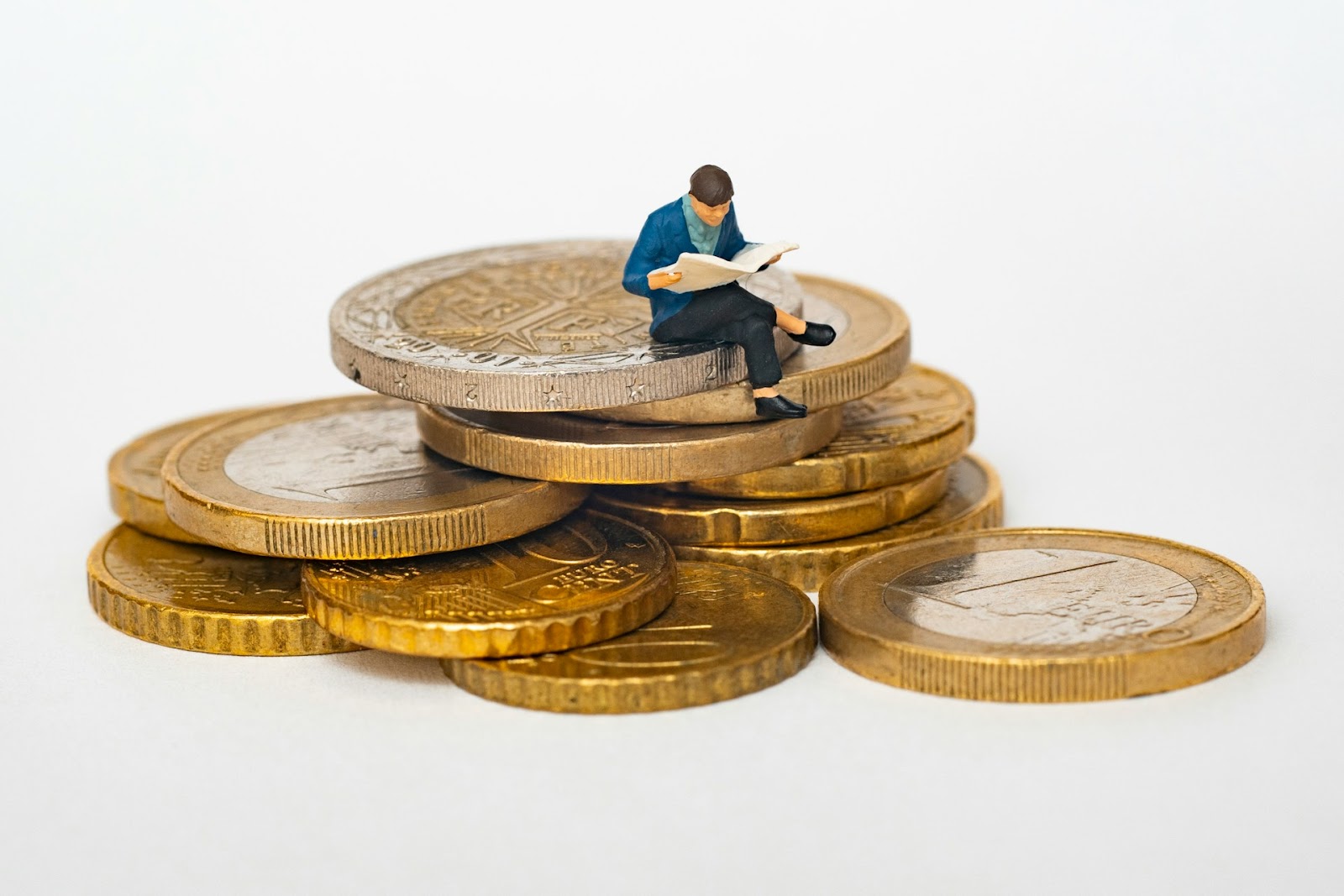 a figurine of a man sitting on coins