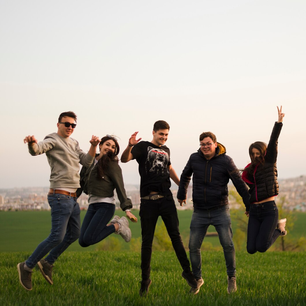 Friends jumping and having fun in nature.