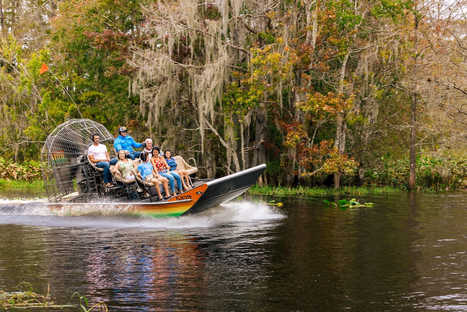 A family enjoys an airboat ride on a sunny day at the Wild Florida Everglades