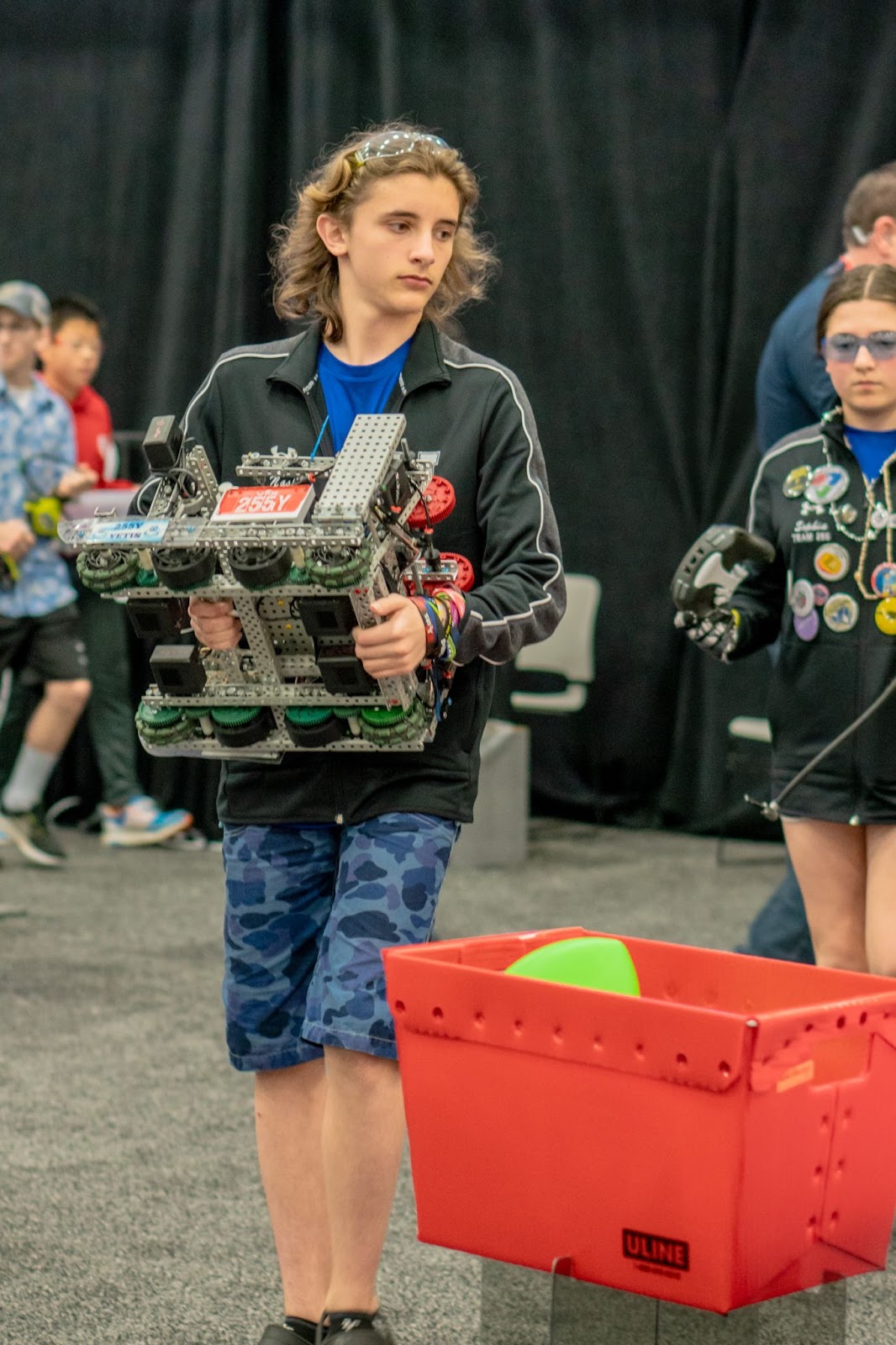 Student carrying robot to playing field