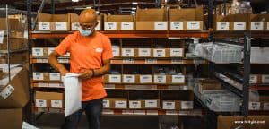 man looking at a box with a paper in his hand