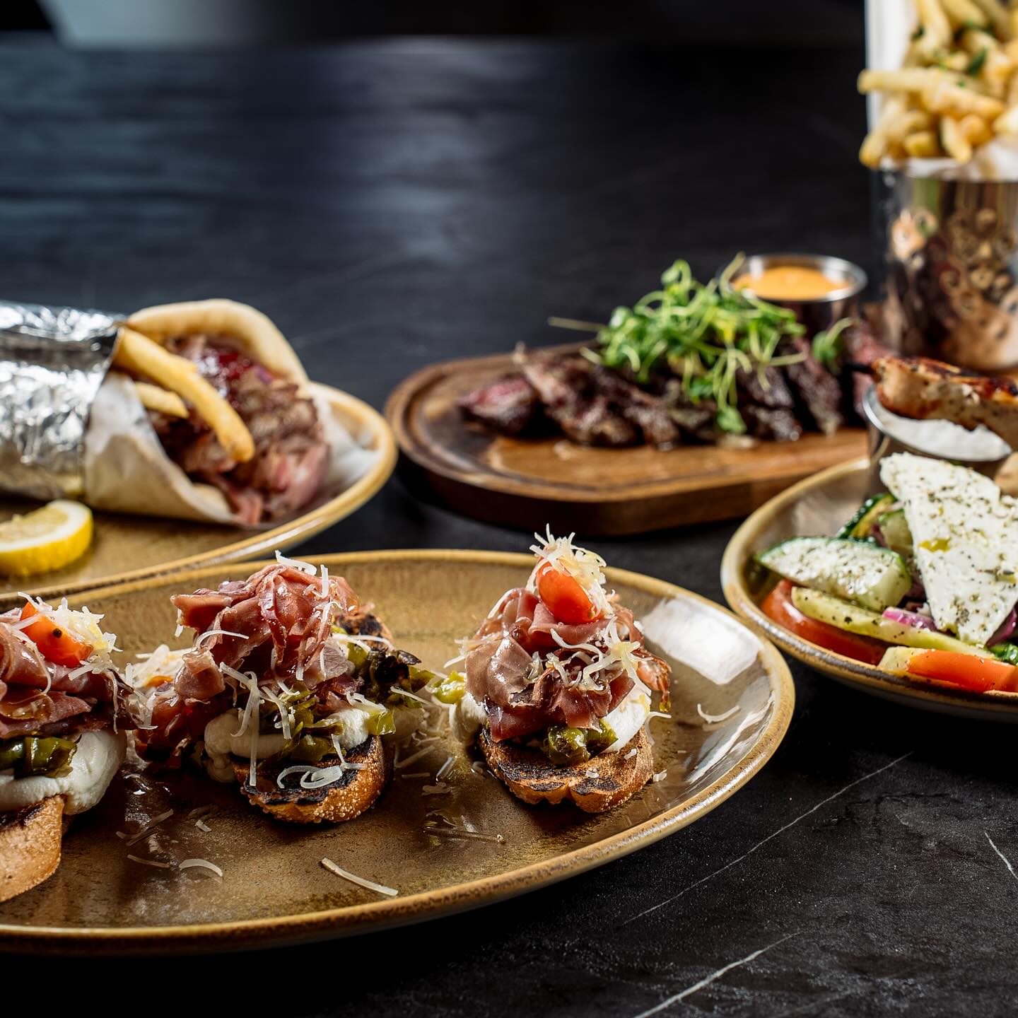 Dishes at Carmine's Eatery including appetizers, meat, and wraps