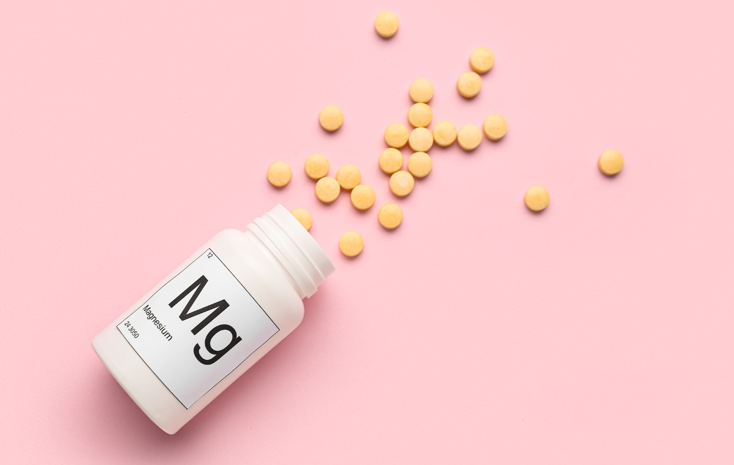 Magnesium supplements in various forms on a wooden table.