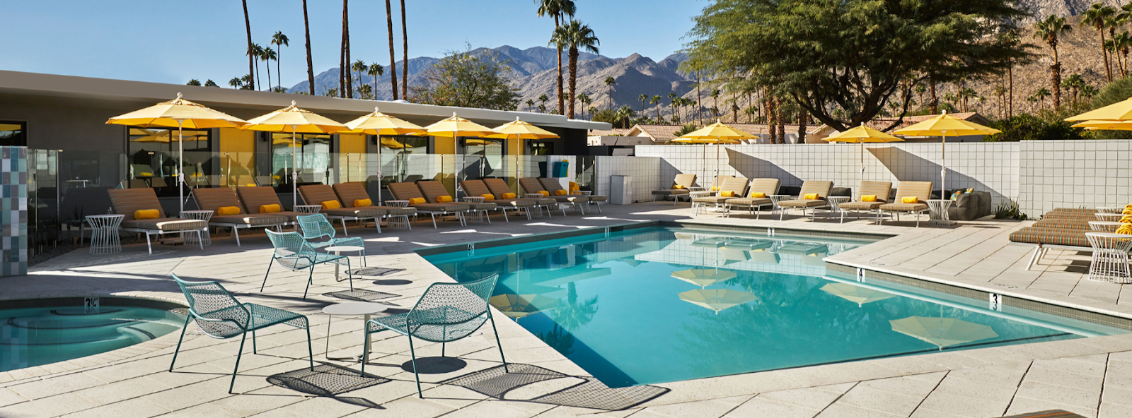 Twin Palms Resort outdoor pool and lounge area showing off the sunny weather and mountain views 