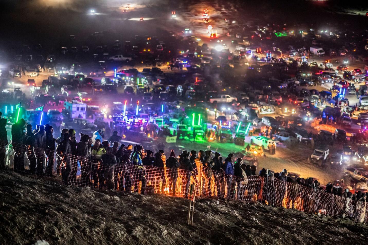 A group of people watching an off-road rally