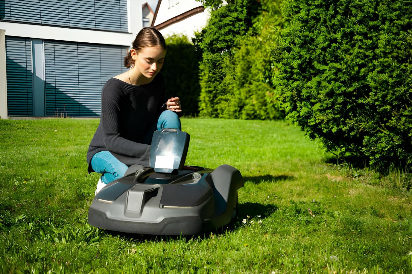 A person sitting on a lawnmower  Description automatically generated
