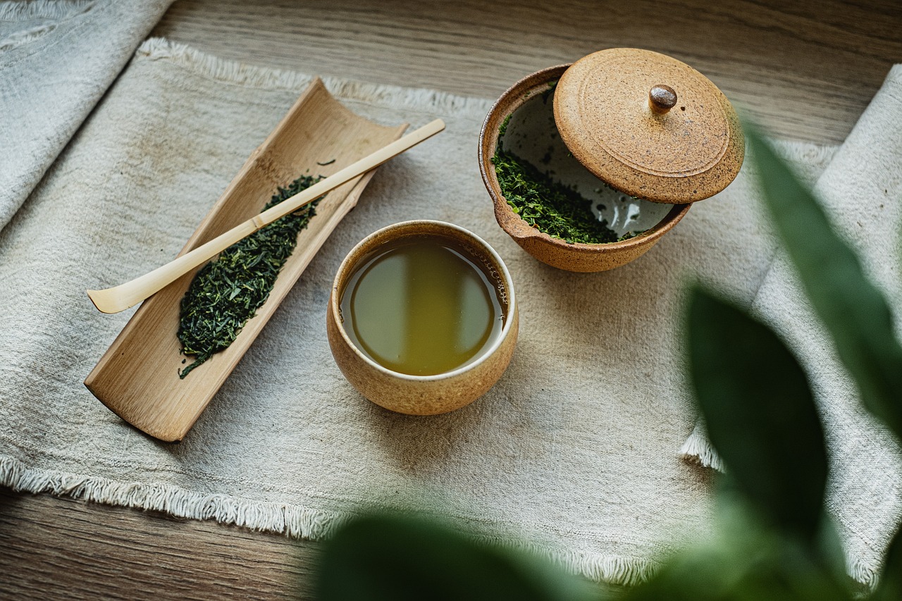 green tea placed on a mat next to a bowl of green tea.