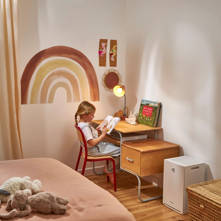 A child sitting at a desk reading a book

Description automatically generated