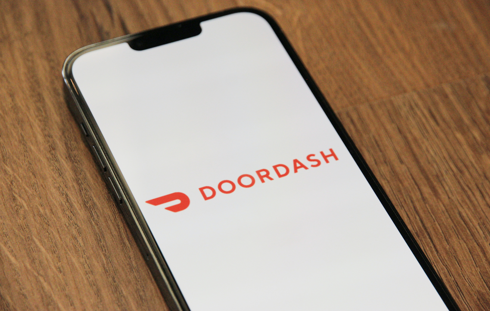 phone that has the doordash app open on it on a table