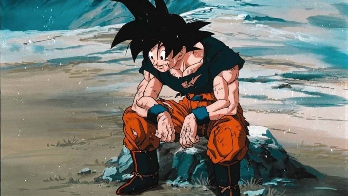 Goku toma un respiro después de la batalla y se sienta sobre una piedra.