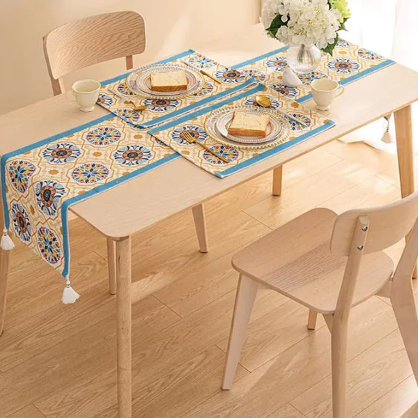 "Large cotton table runner featuring a vibrant blue and orange pattern with tassels, perfect for festive Hari Raya table settings "