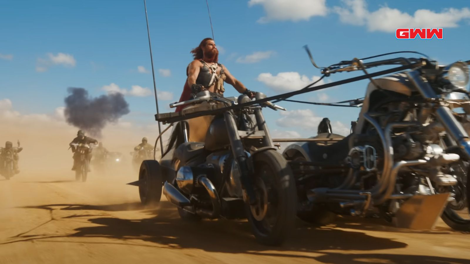 Muscular man driving a motorbike in a desert chase.