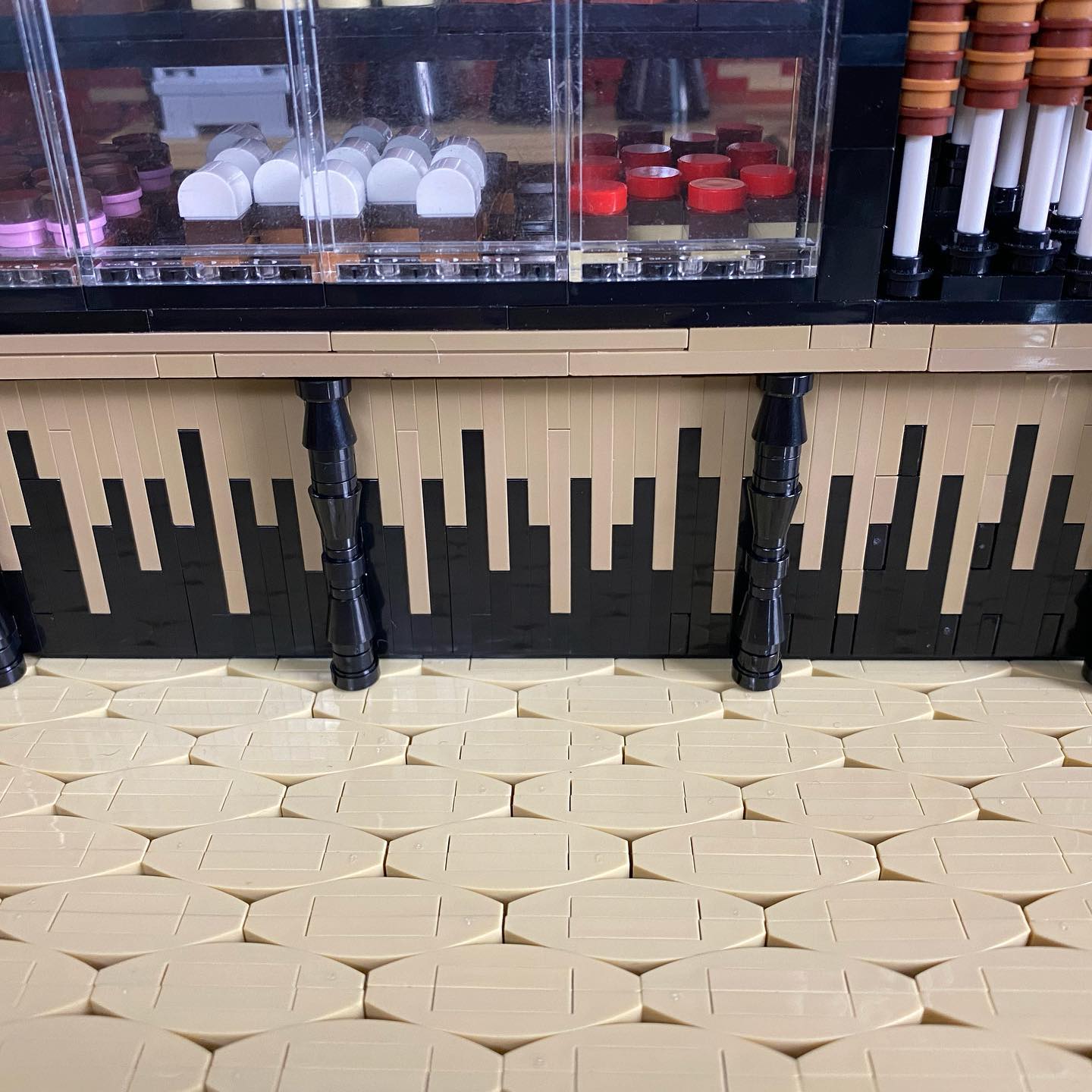 A close-up photograph of Kelly Bartlett's Chocolate Shop countertop, displaying a pattern that evokes dripping chocolate