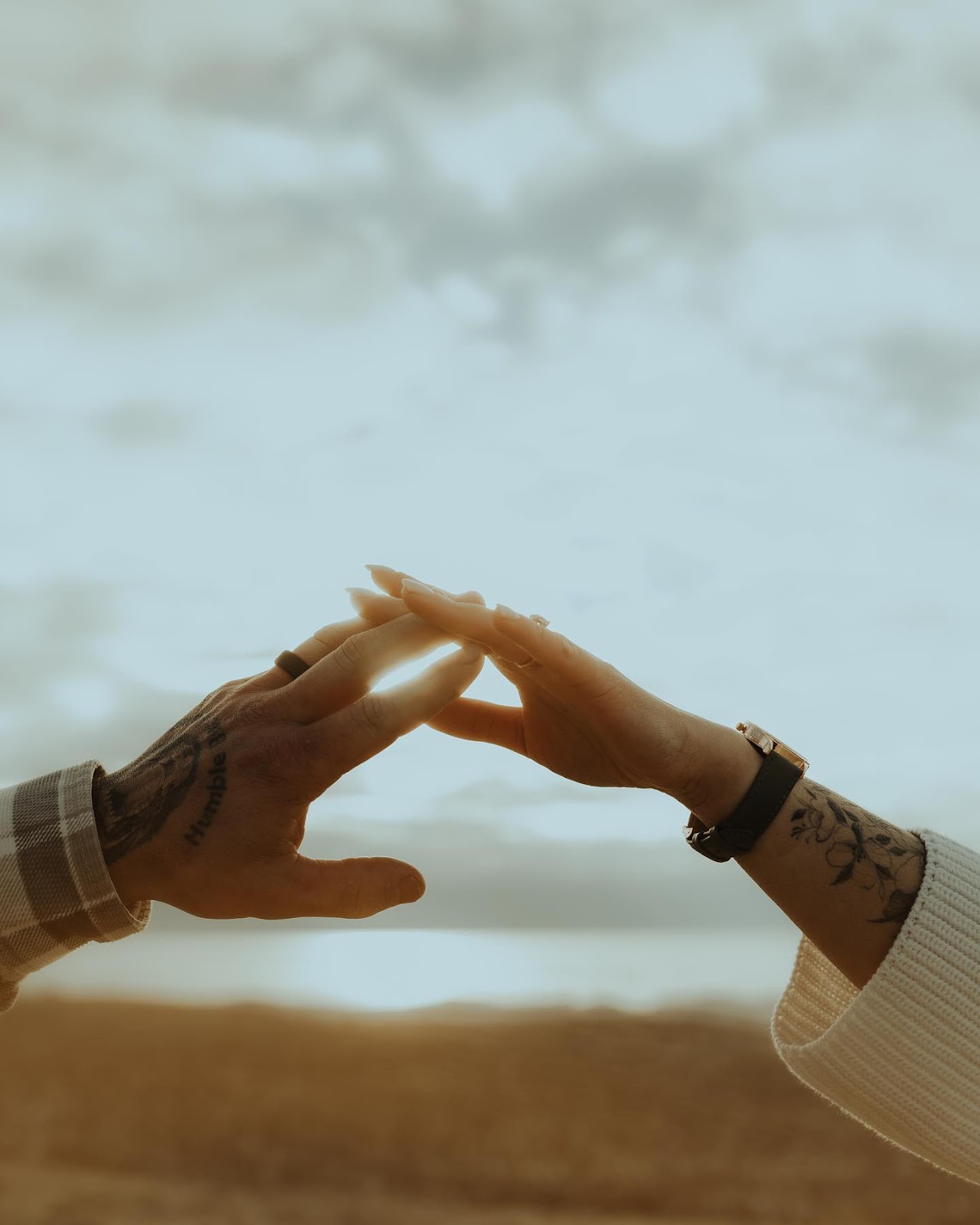 Two hands connecting wearing matching silicone rings