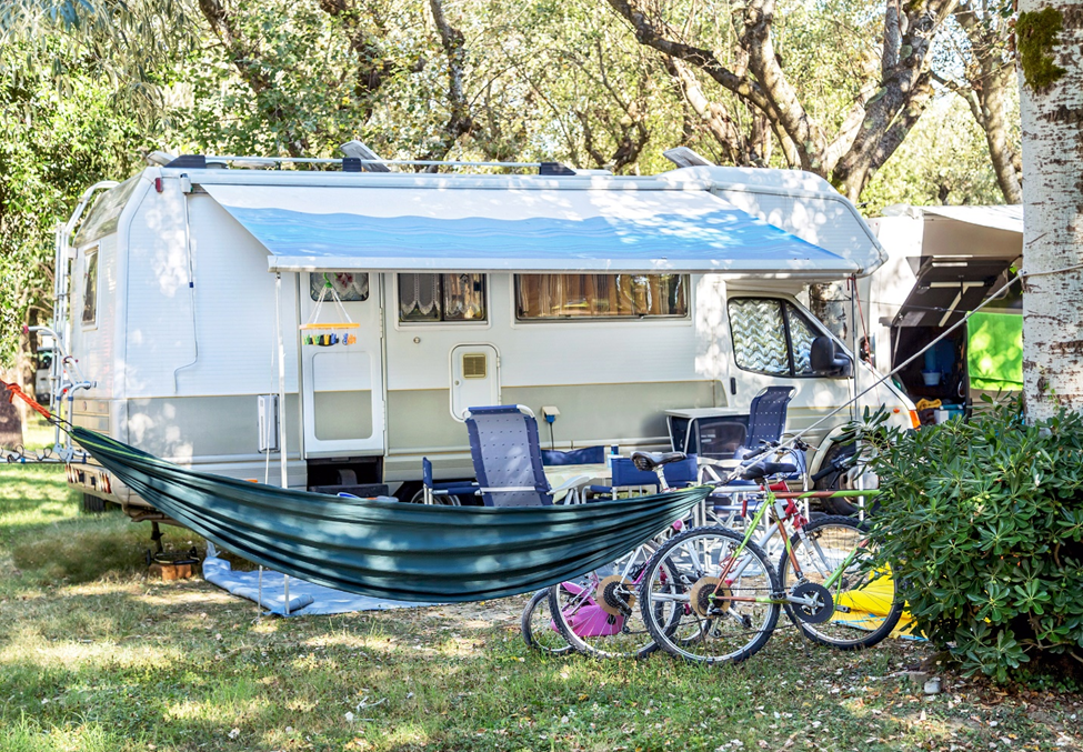 An RV and hammock setup with bikes. 