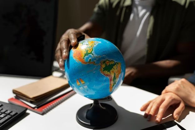 Man holding a globe, symbolising global opportunities in international relations.