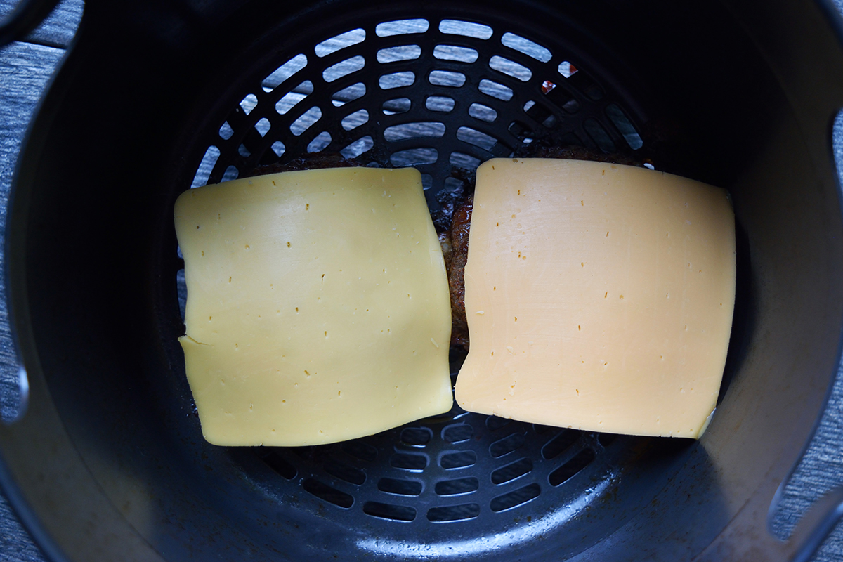 Two pieces of cheese cooked in an air fryer.