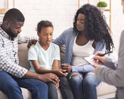 young adult talking to a therapist in an office