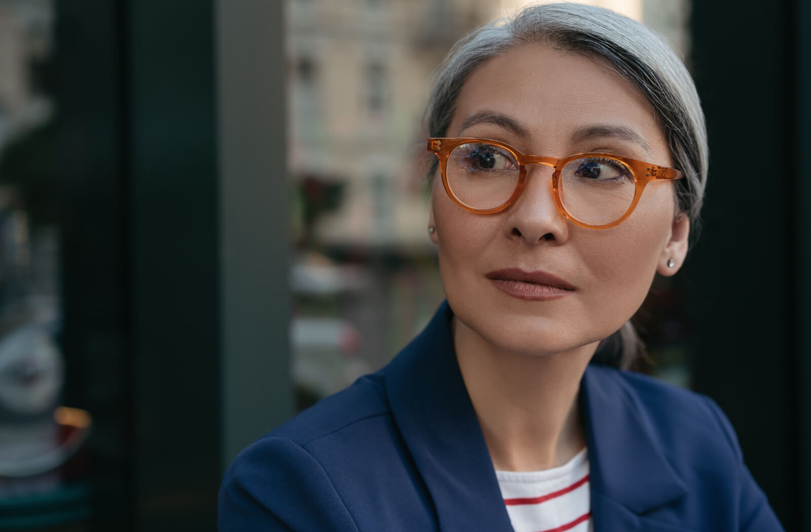 A close-up of a professional-looking woman wearing a stylish pair of glasses.