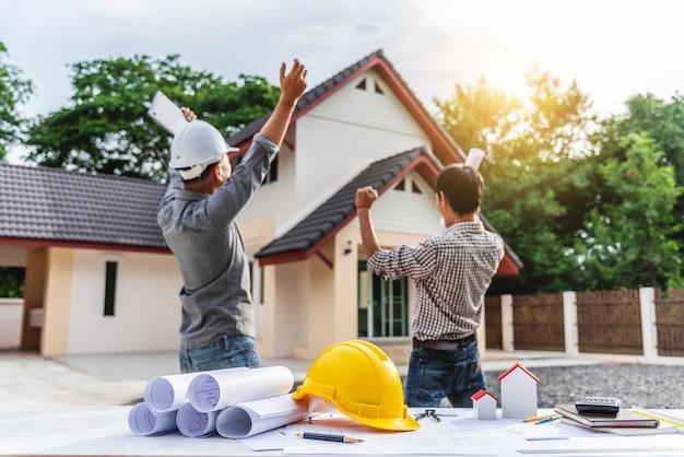 Photo two business man professional engineer worker at the house building.