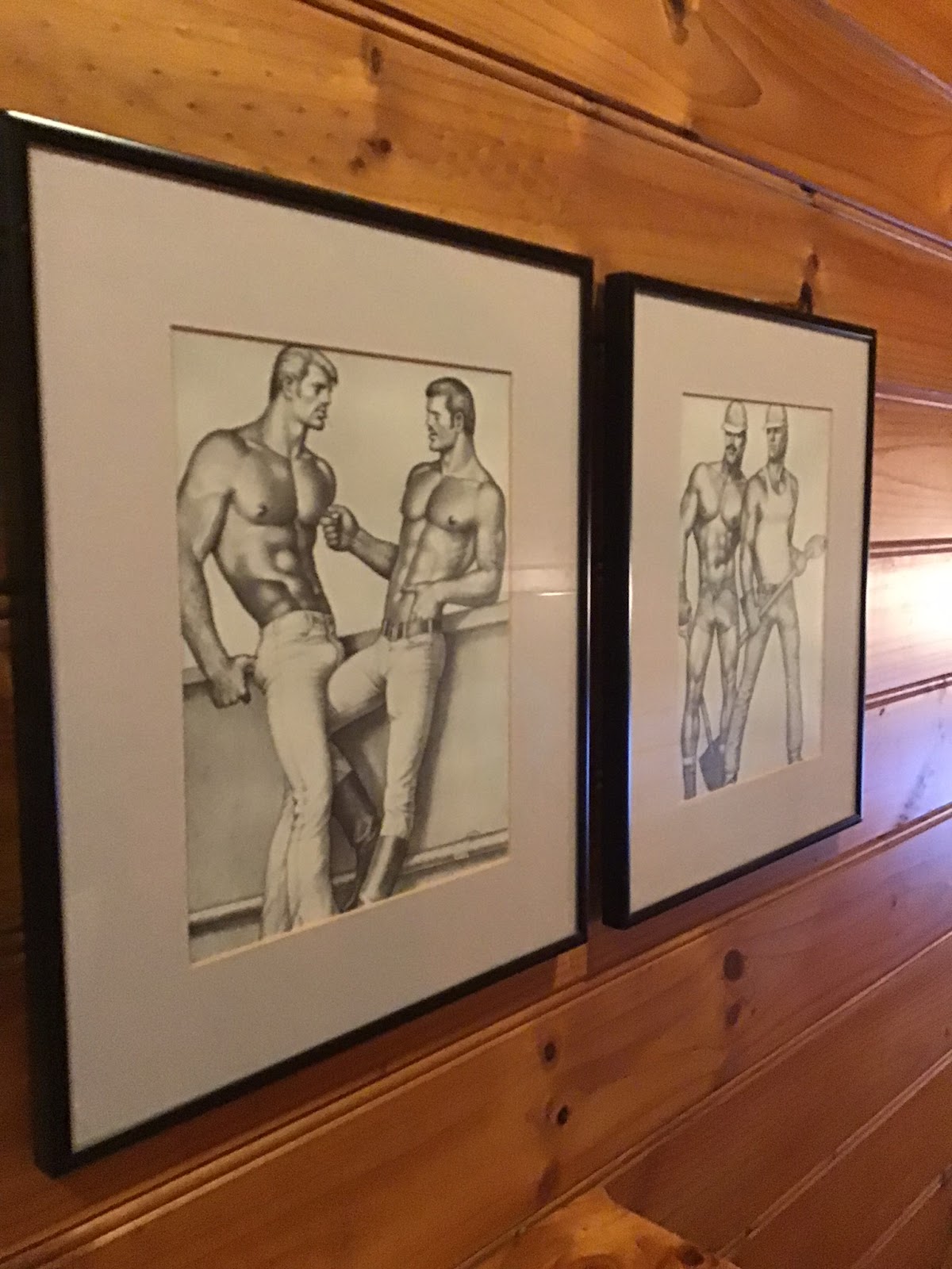 framed photos of tom of finland illustrations hanging on the wall of the laird guesthouse in melbourne australia