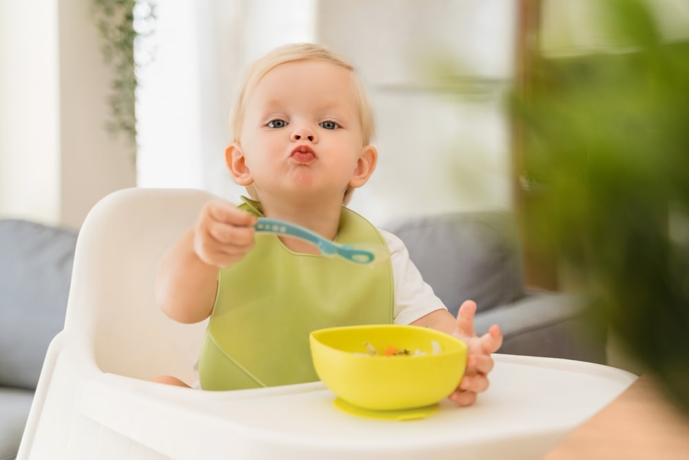 adorable three month old child feeding 