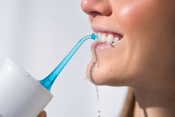 using water flosser for removal food particles stuck between your teeth