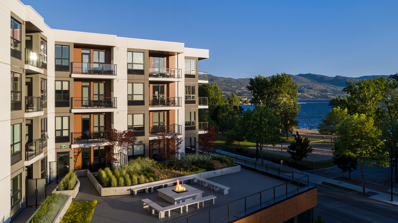 the exterior of The Shore Kelowna, overlooking Gyro beach volleyball courts and Okanagan Lake