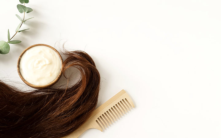 female hair hair mask and bamboo comb on top view