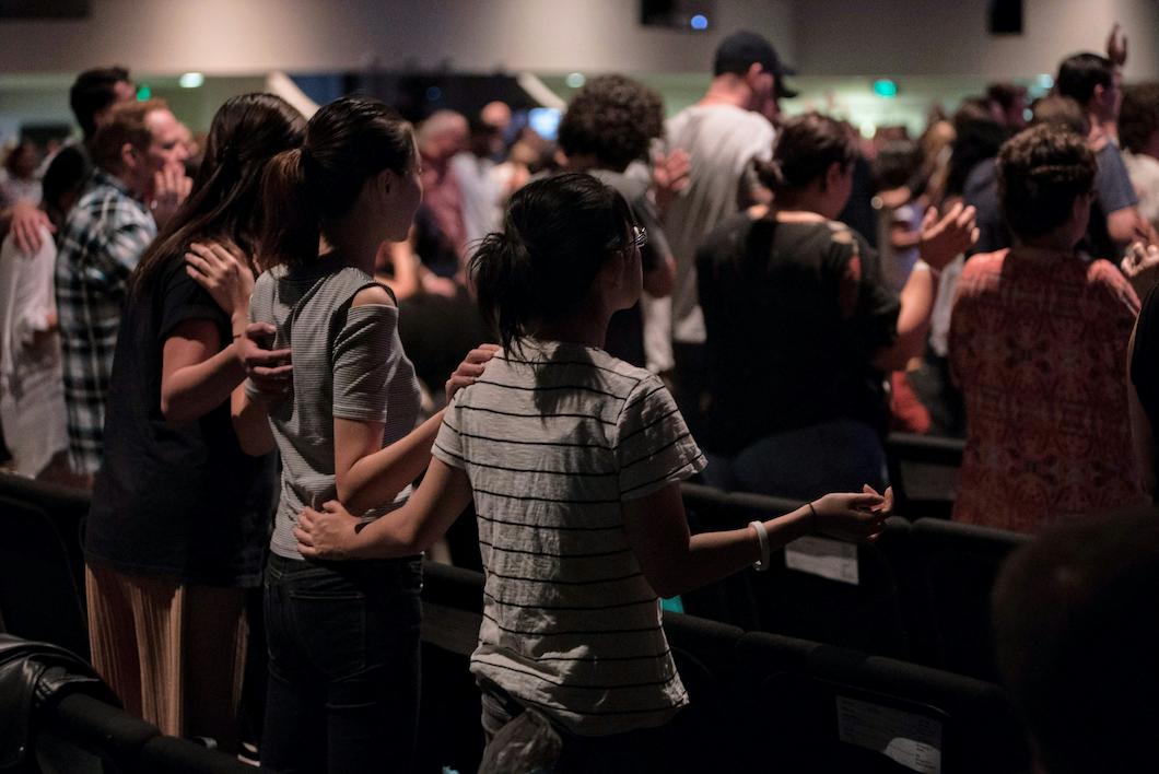 A christian event with an audience of different ages and genders.