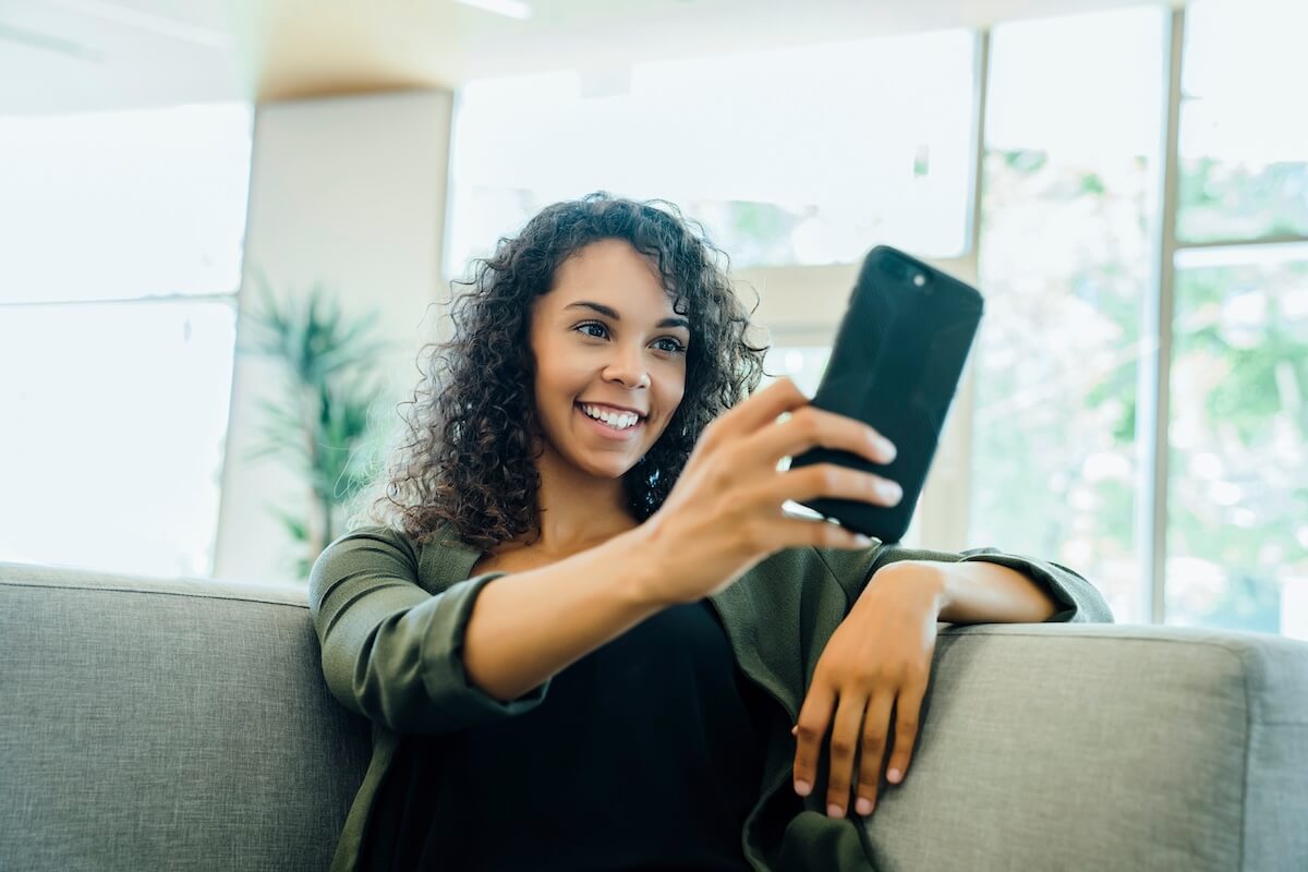 What is patient engagement: woman happily using her phone