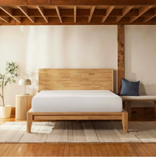 A medium brown wooden bed frame and matching headboard from Silk and Snow