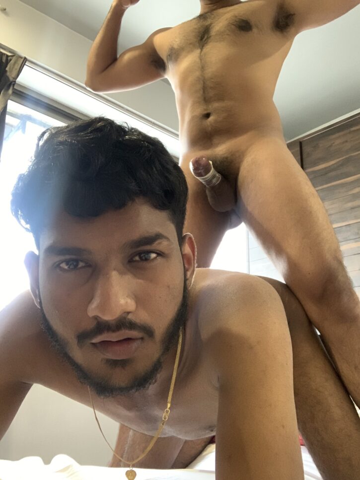 Mr Yuvii looking at the camera about to get fucked by anoymous naked indian gay male wearing a condom