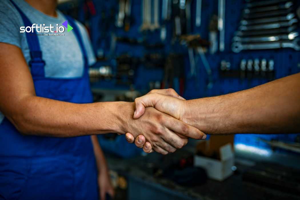 Two people shaking hands in a workshop