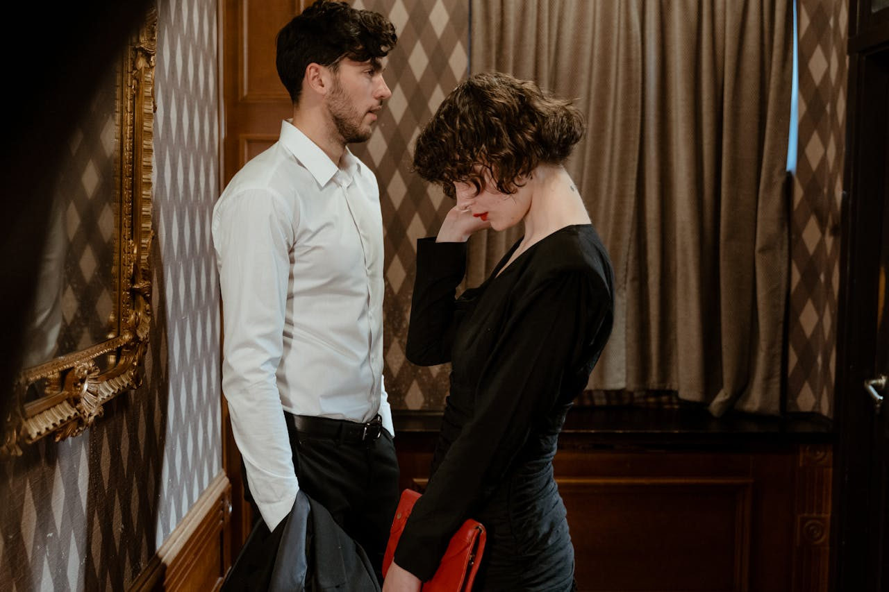 A man stands awkwardly in an elevator next to an awkward woman - https://www.pexels.com/photo/a-man-and-a-woman-standing-next-to-each-other-9566326/