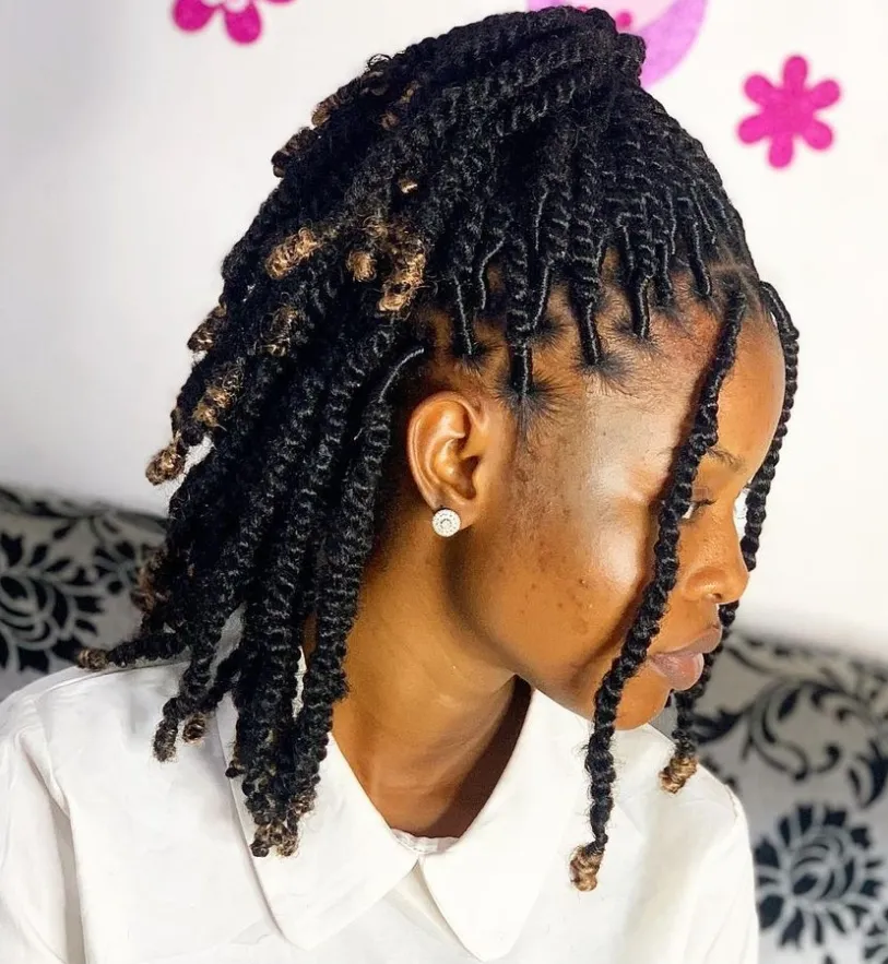Kinky Twist: Full picture of a lady styling hair half  up half down