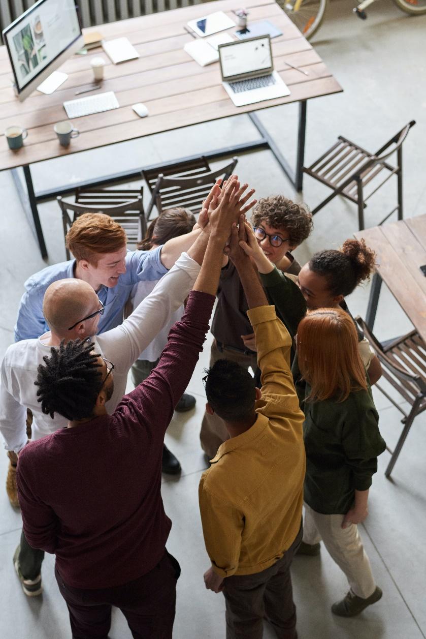 A group of people giving each other a high five

Description automatically generated