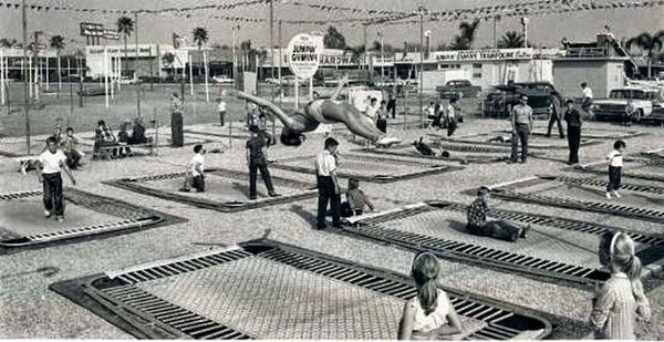 Multiple people jumping at a Jump Center in the mid-20th Century.