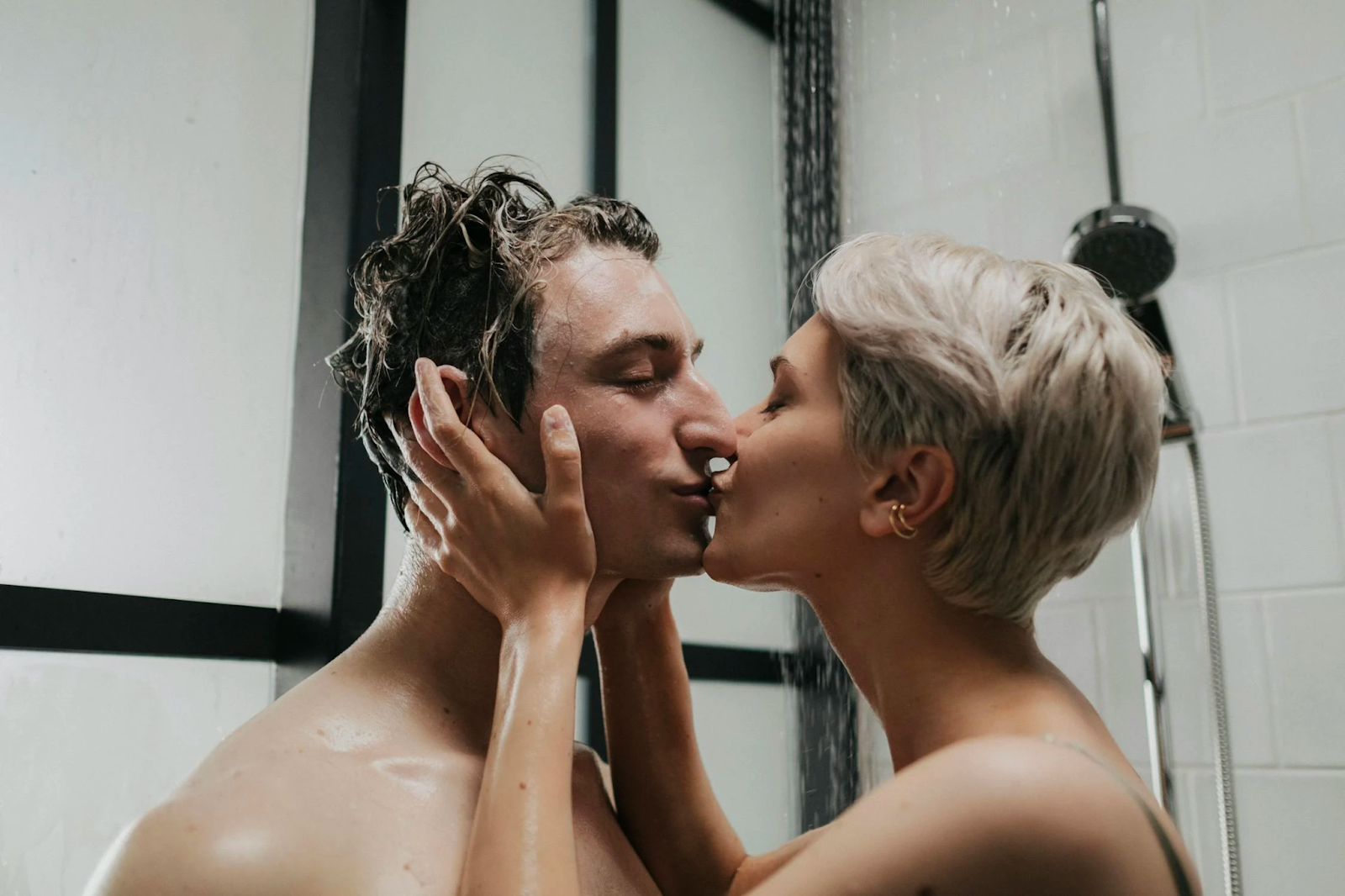 A man and woman kissing in the shower