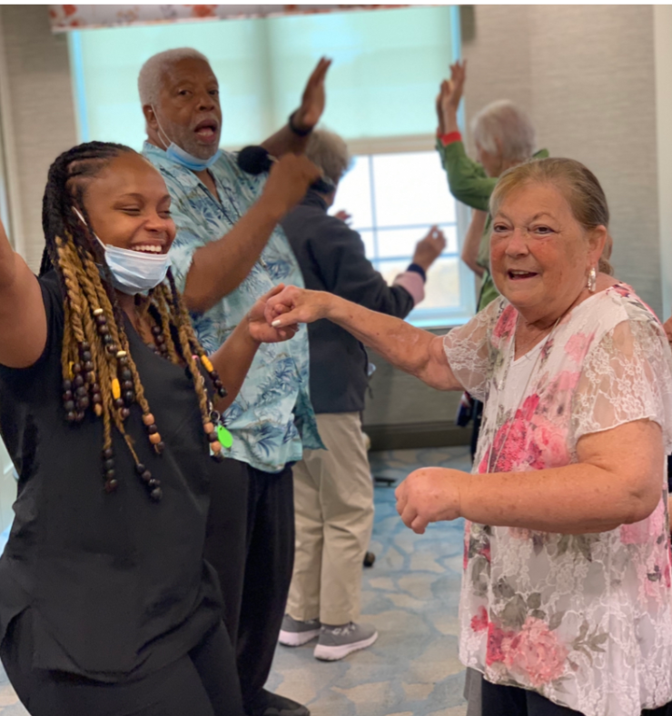 People dancing in a room together and smiling