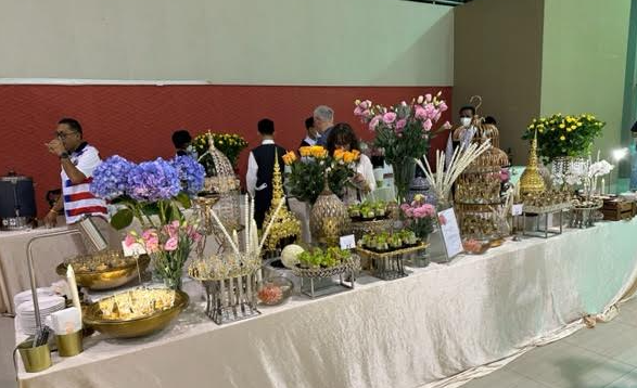 A table with flowers and other objects on it

Description automatically generated